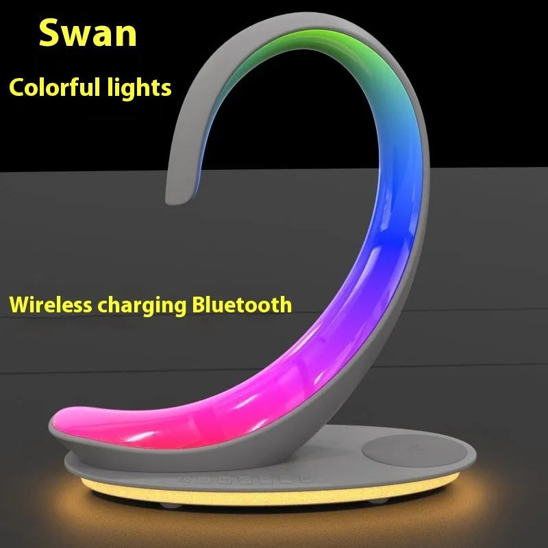Multi-functional white swan desktop light with wireless charger, Bluetooth speaker, and colourful atmosphere light on a desk