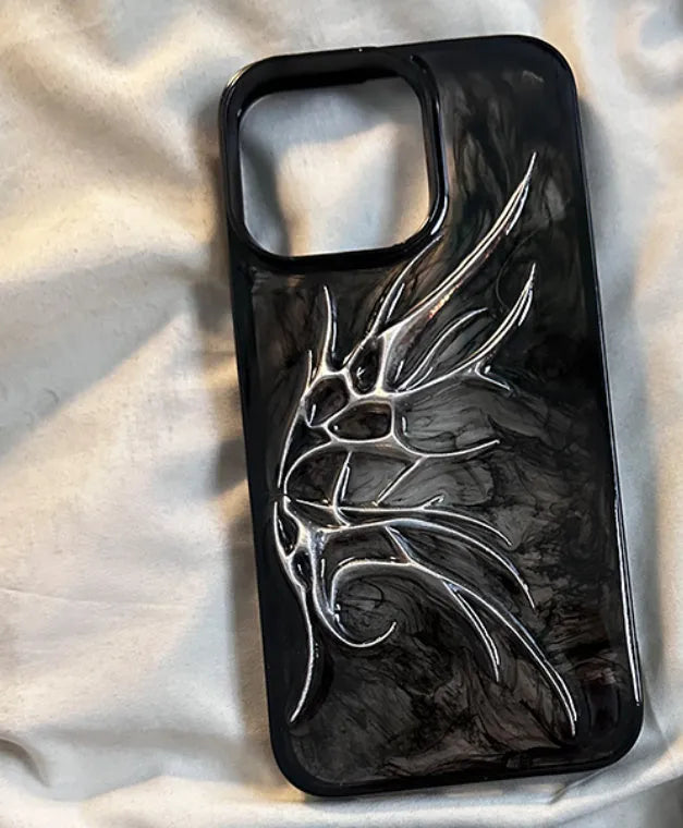 Black iPhone case with three-dimensional wings design showing textured surface