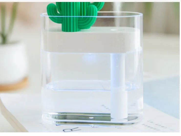 Transparent green cactus-shaped portable USB humidifier on a desk, 120mm tall