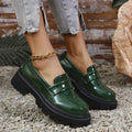 Women's black slip-on loafers with a chunky platform heel and rubber sole.