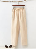 Man wearing beige pure cotton casual trousers with a drawstring waist and belt.