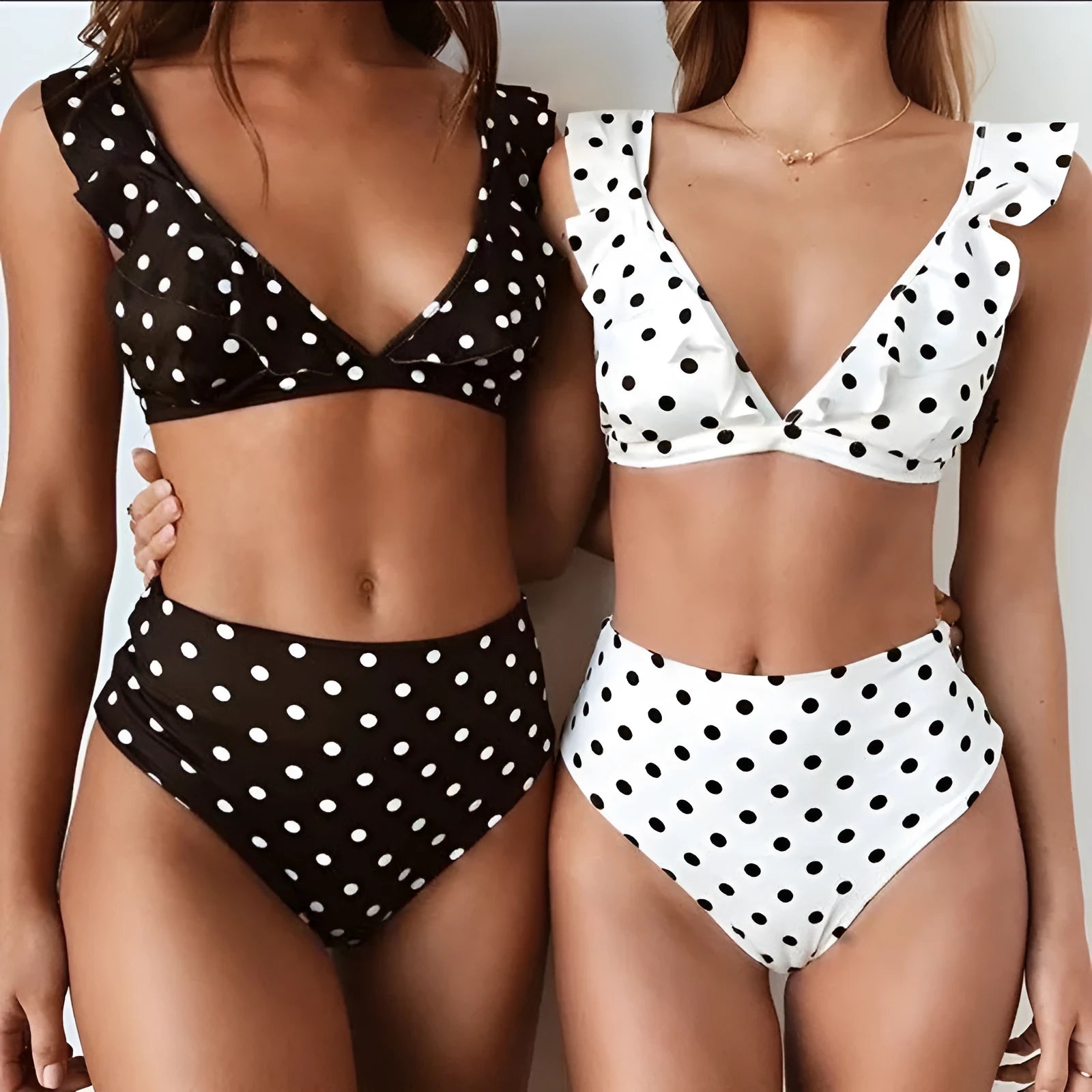 Black and white polka dot print bikini set with deep V-neck top and ruffled design