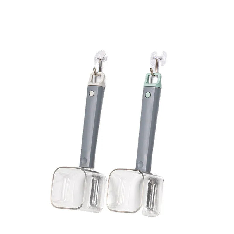 Green, grey, and red stainless steel kitchen peelers with plastic handles on a white background.