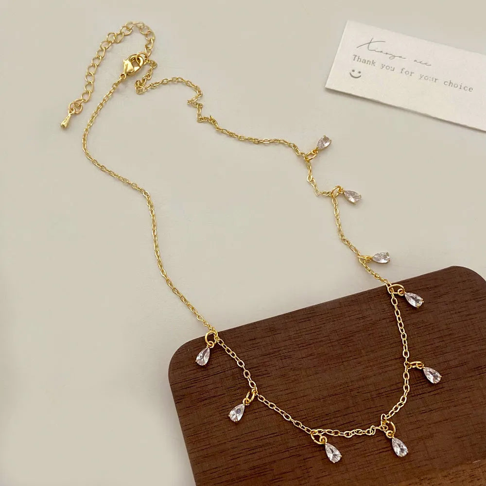 Silver-tone zircon jewellery set with geometric meteor shower pendant necklace, matching earrings and anklet