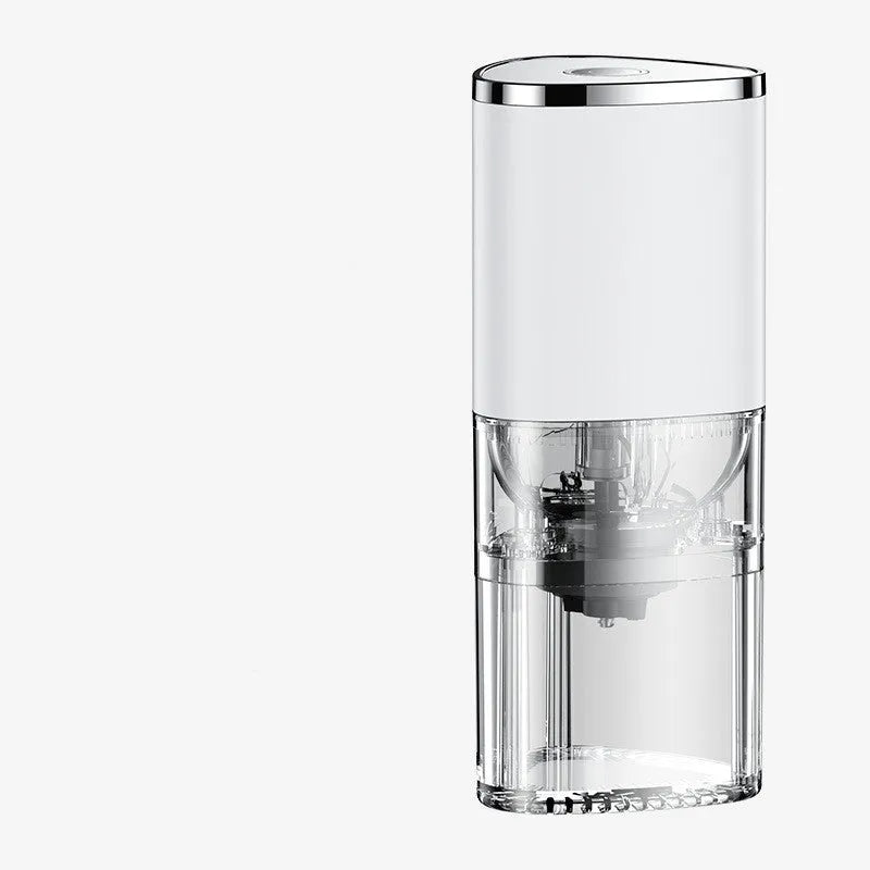 White portable electric coffee grinder with ceramic burr and USB charging cable on a kitchen counter.