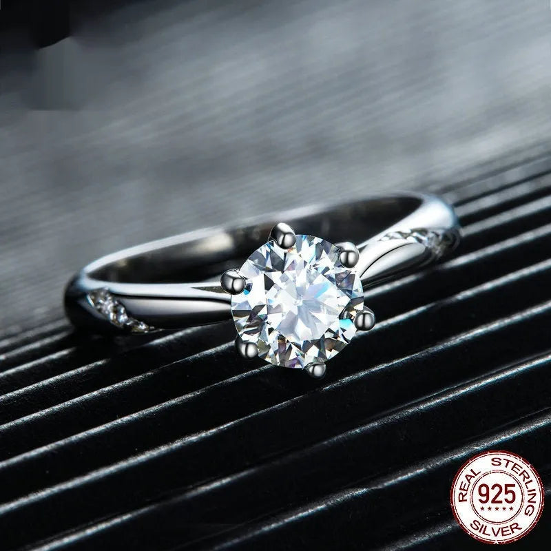 Silver moissanite ring with 1 karat main stone, electroplated finish, size US7 on a white background.