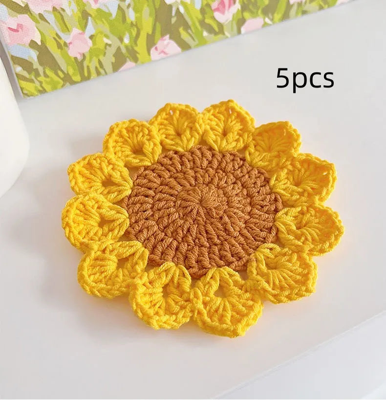 Hand-woven wool flower coasters showing floral pattern texture and natural wool material