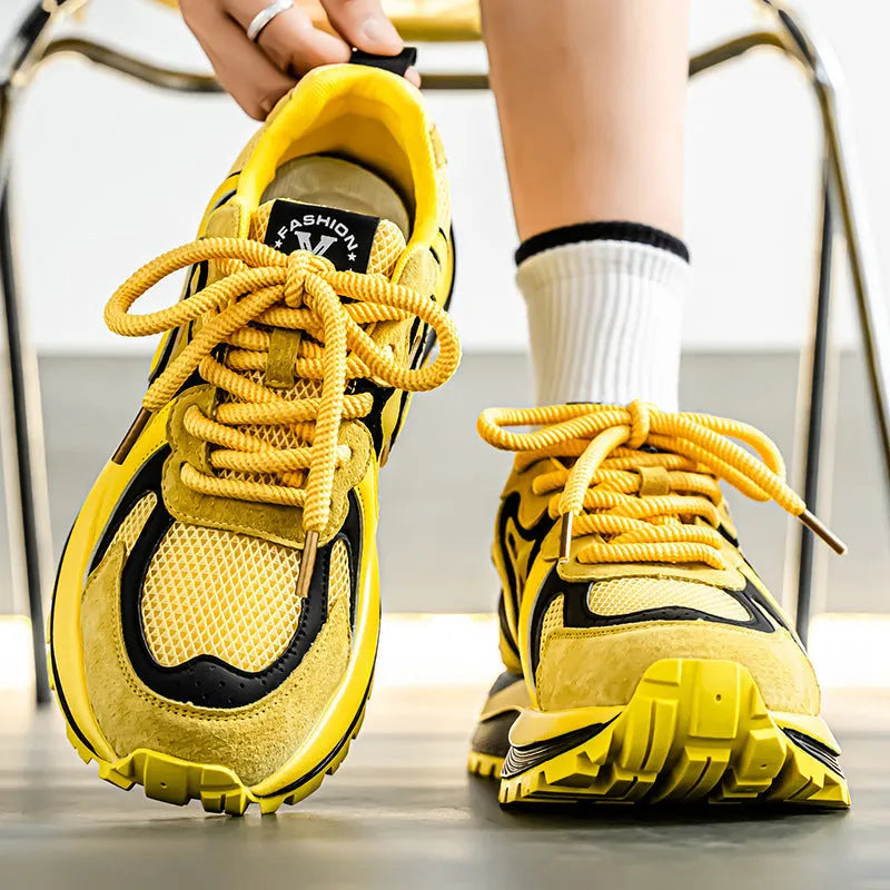 Men's yellow synthetic leather and mesh casual sneaker with rubber sole and lace-up front.