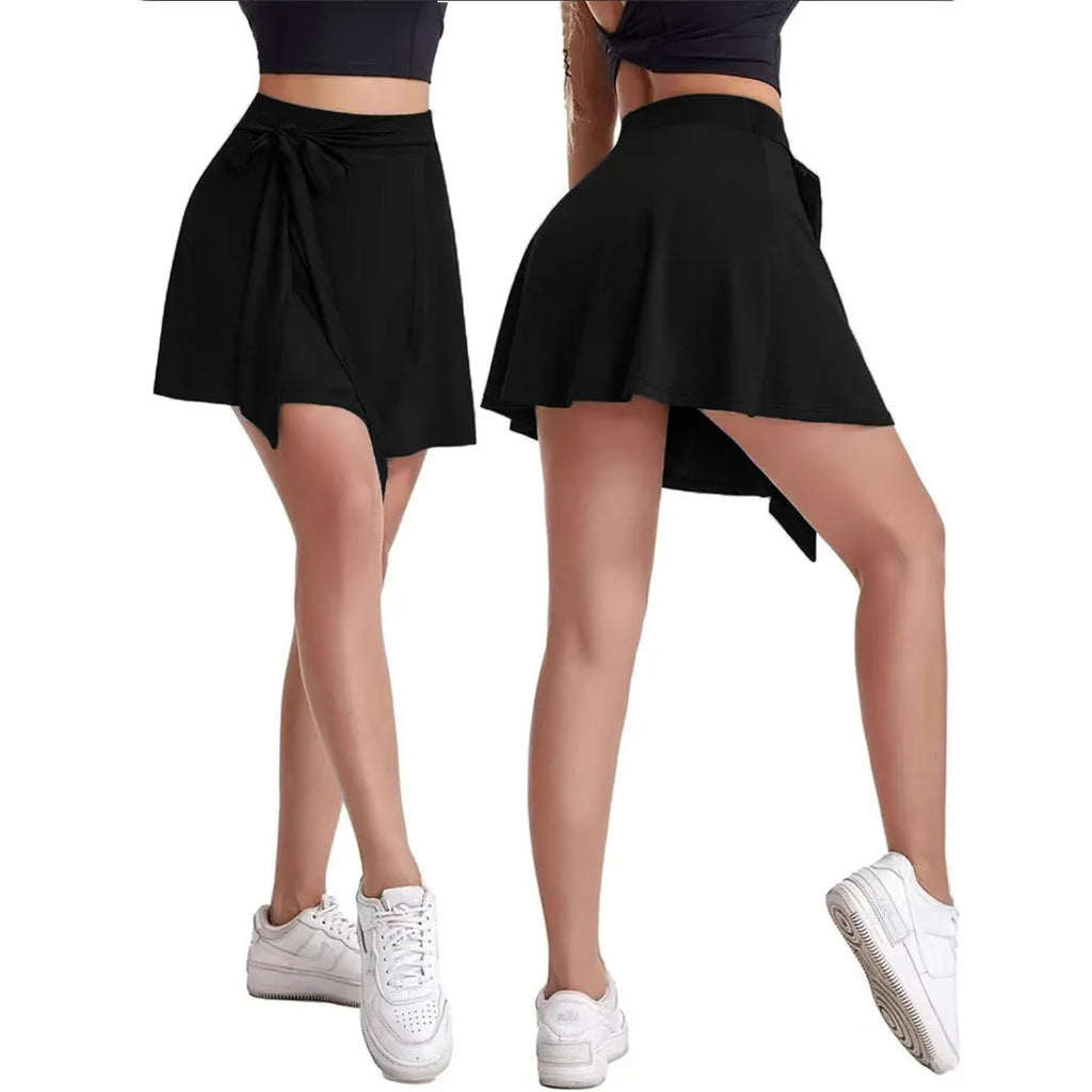 Black thigh-length sports skirt with anti-exposure shorts, high waist design, and shoulder strap detailing