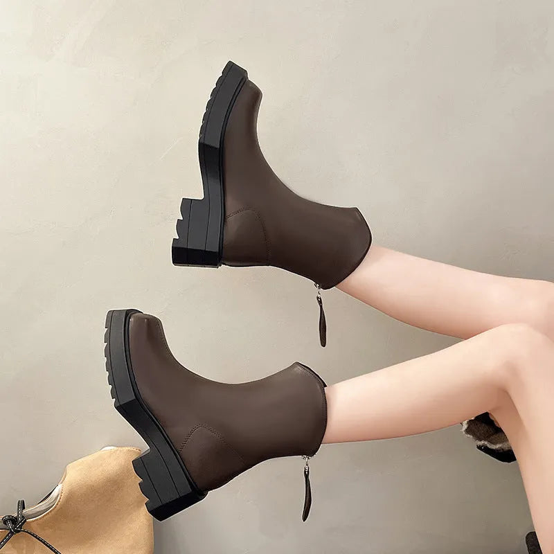 Black women's platform Martin boots with a square toe, high heel, and back zipper on a neutral background.