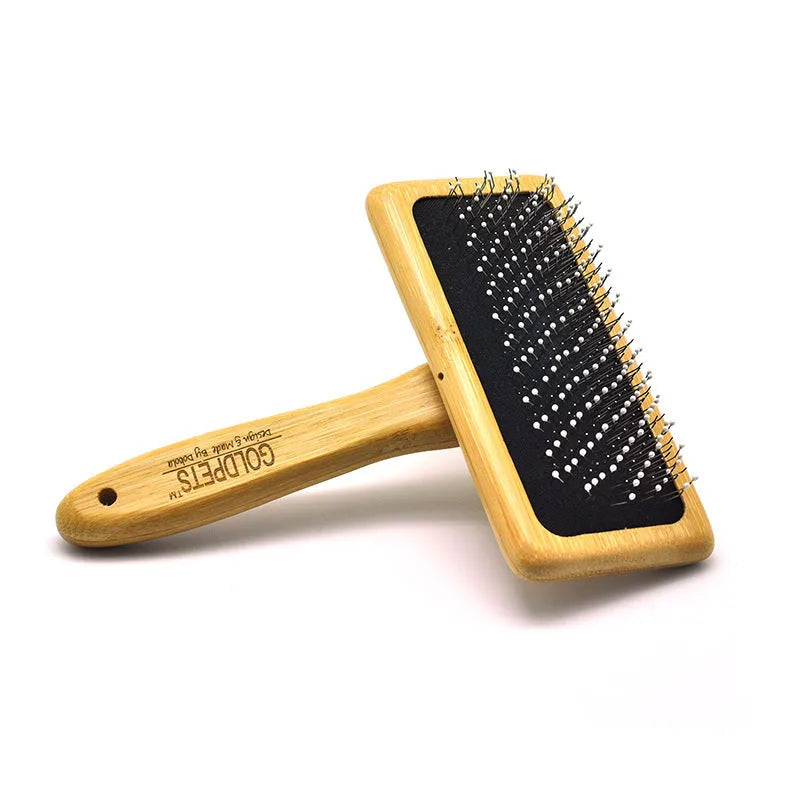 Pet grooming bamboo wood air cushion needle comb with original bamboo colour handle and steel pins on a clean background