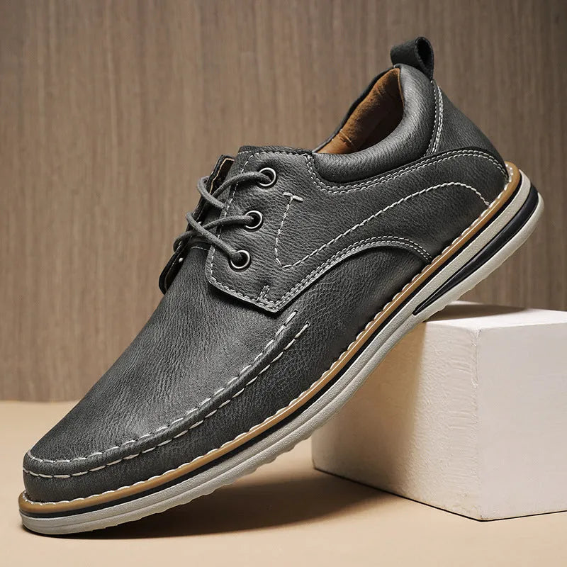 Men's black genuine leather casual lace-up shoes with round toe and rubber sole on a white background.