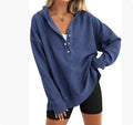 Women's loose peacock green raglan sleeve pullover sweater on a hanger.