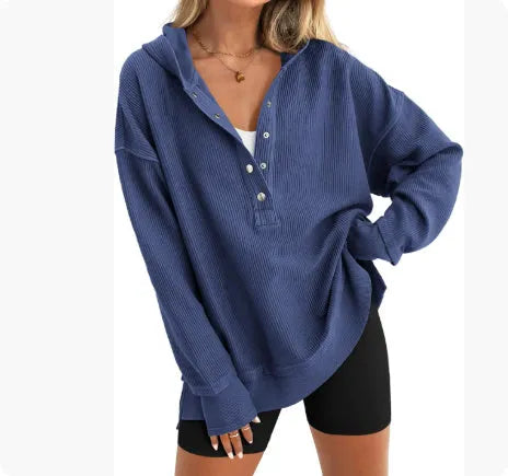 Women's loose peacock green raglan sleeve pullover sweater on a hanger.