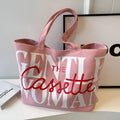 Letter printed canvas tote bag in off white with car stitching detail and top handles