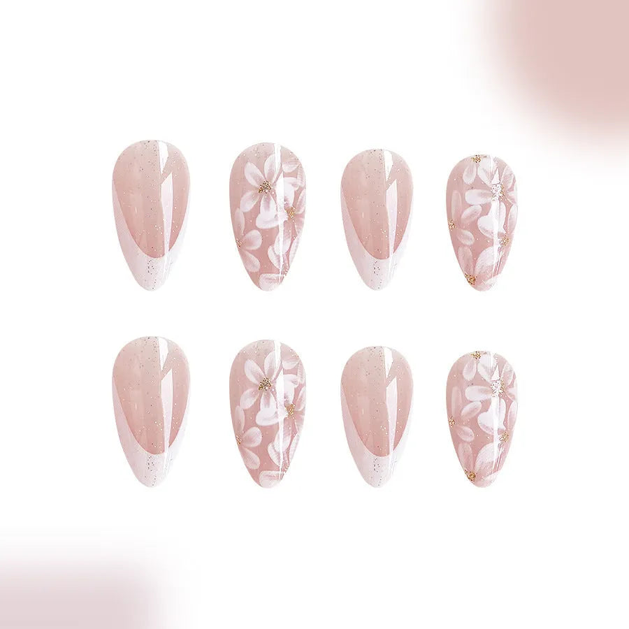 Short almond shaped artificial fingernails with French tips and glitter powder flower decorations, colour C625.