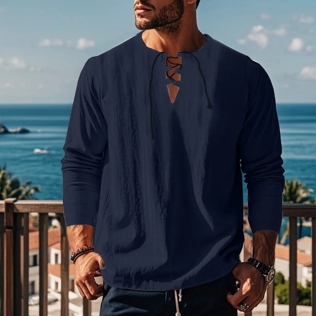 Man wearing a loose fit solid colour cotton linen beach shirt in a casual setting.