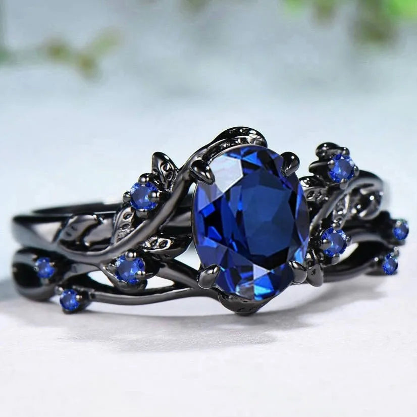 Geometric gun black women's couple ring with a navy blue rhinestone inlay on a copper band.
