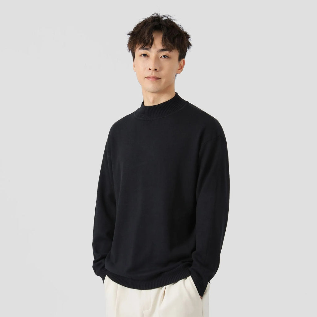 A man's loose-fitting, long-sleeve pullover sweater in a solid colour, showing a casual relaxed fit.
