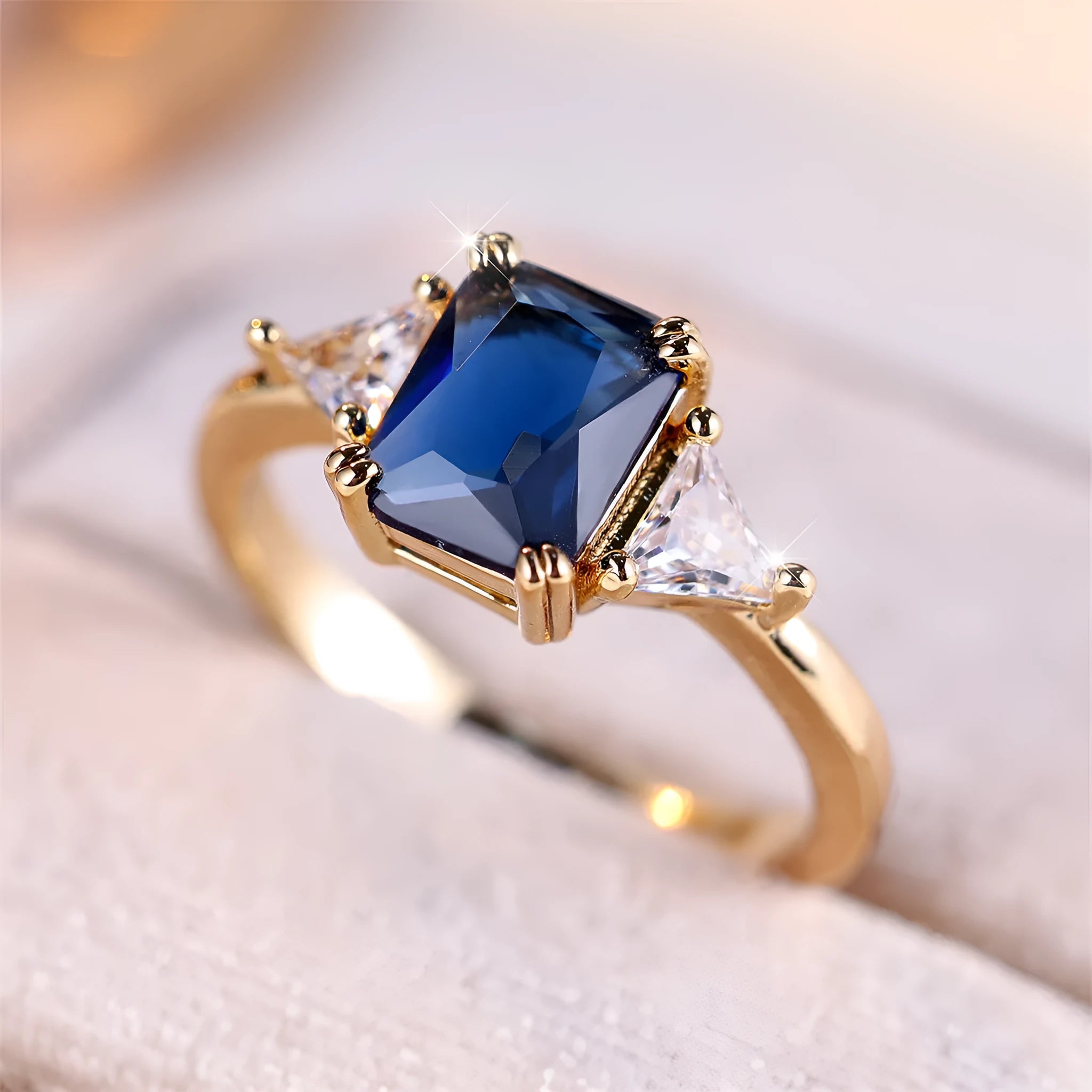 Rectangular gold sapphire blue copper women's ring showing geometric band shape