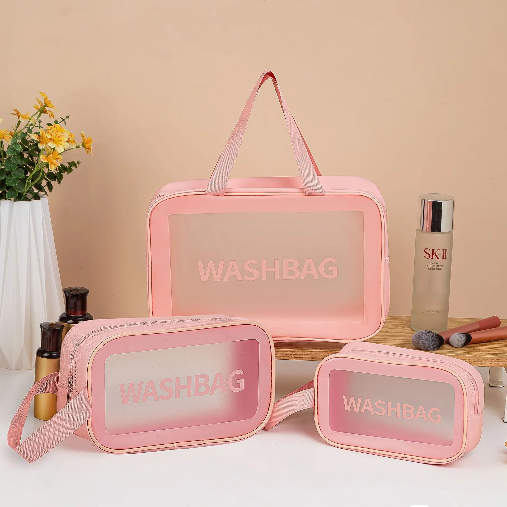 Large PVC transparent cosmetic bag three-piece set in various colours including beige, black, blue, pink, and white, empty and open on a flat surface