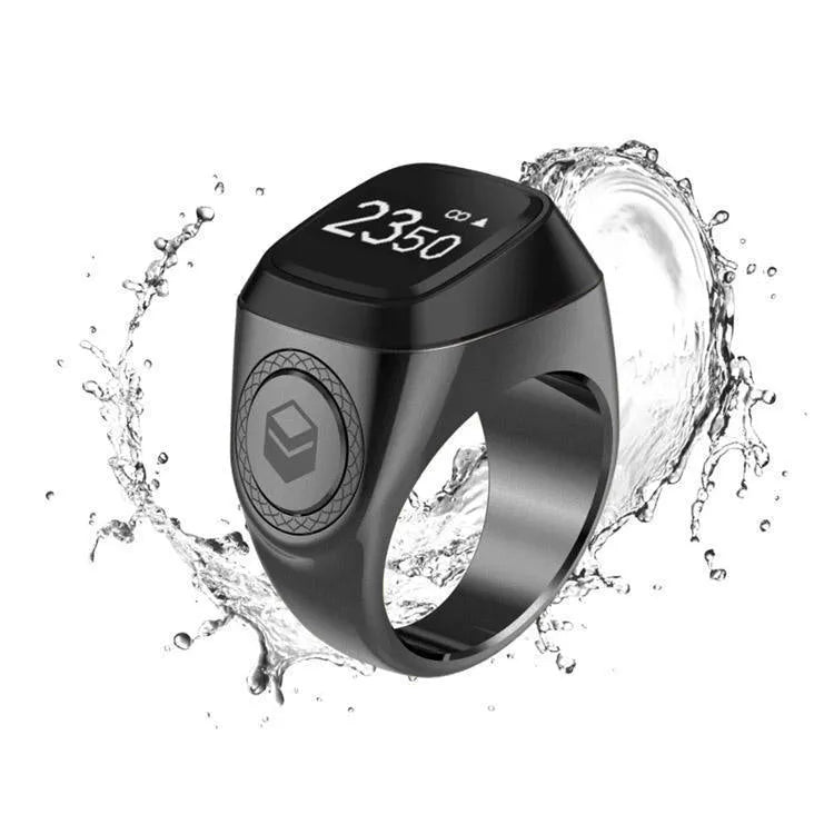 Zikr1 smart ring in silver on a finger, showing the OLED display and single CNC button.