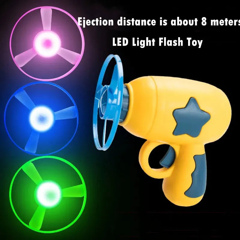 Blue flying saucer launcher gun and three LED flashing discs on a yellow background.