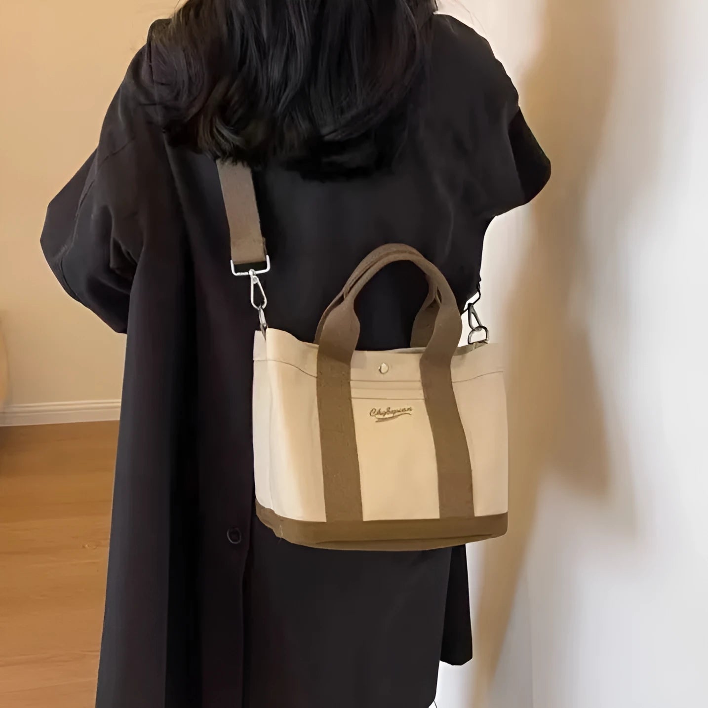 Beige soft canvas bucket-shaped messenger bag with sandwich pockets and three shoulder straps
