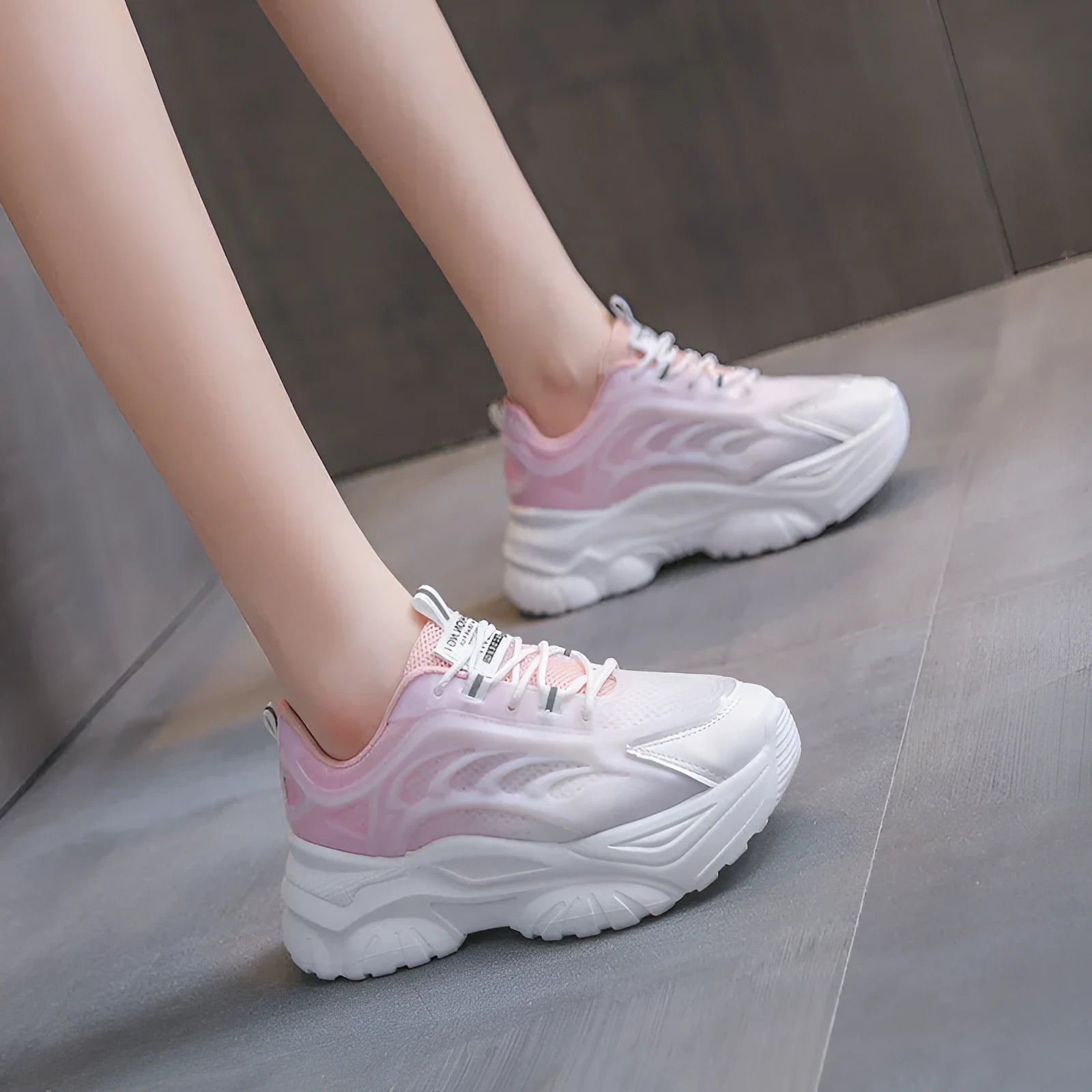 Women's blue satin casual sport shoes with round toe and white laces on a flat lay.