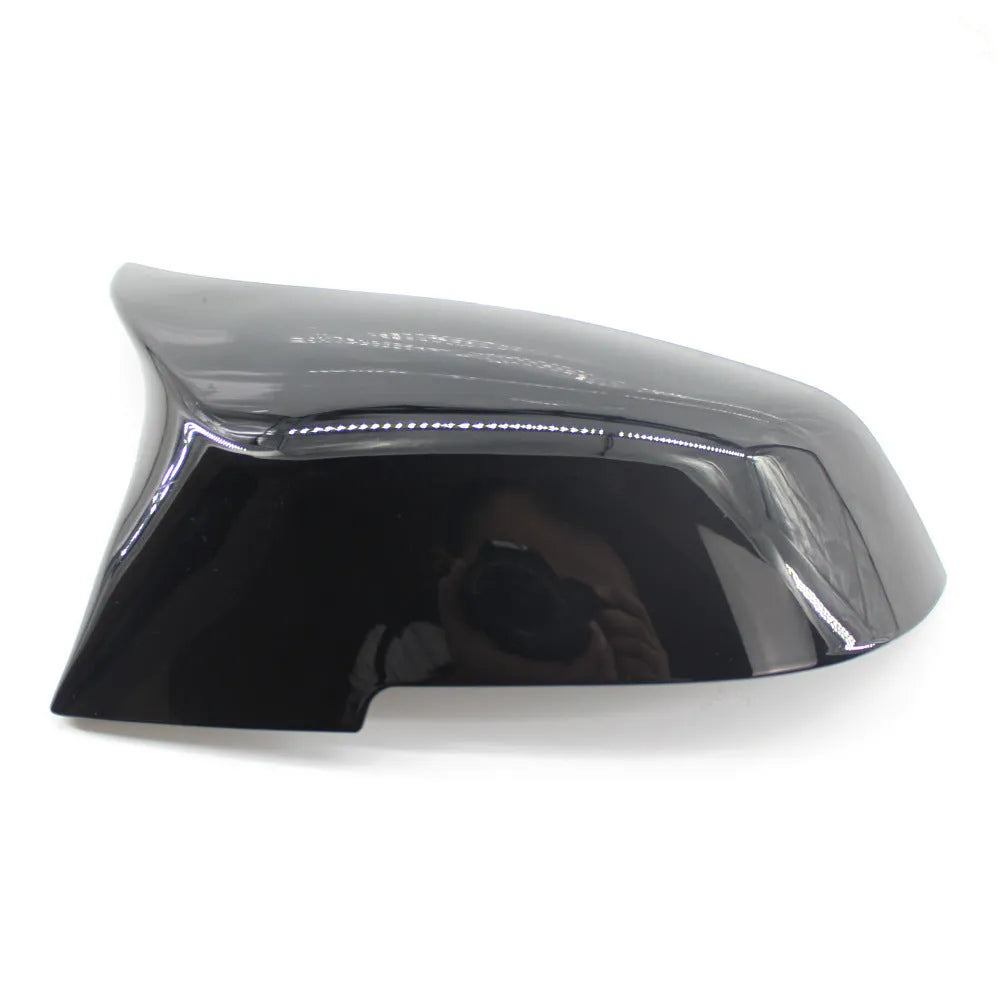 Pair of paint bright black BMW F-Series rear-view mirror replacement shells.