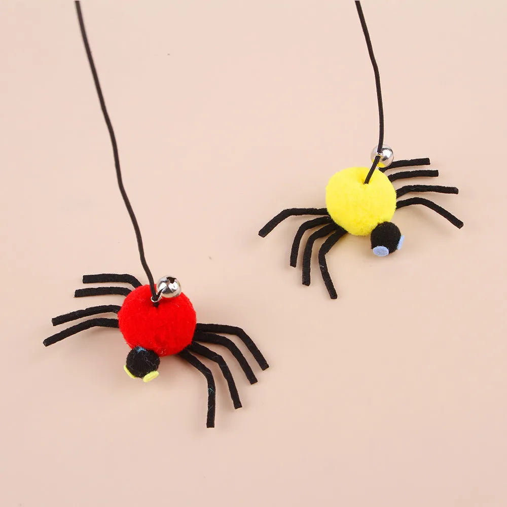 Red and yellow feather cat toy hanging from door on elastic rope with bell spider element for indoor feline play