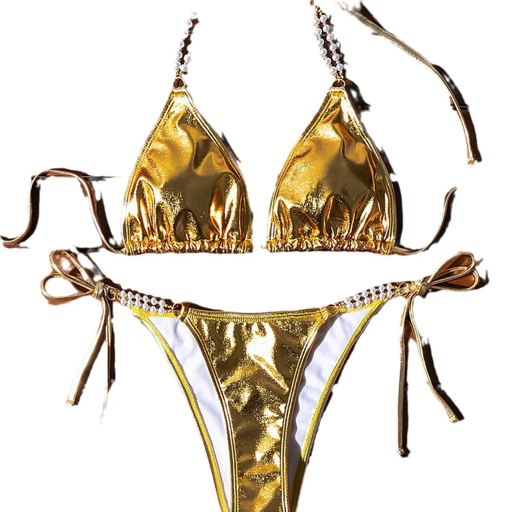 Gold halter lace-up bikini swimsuit with pearl chain detailing on mannequin