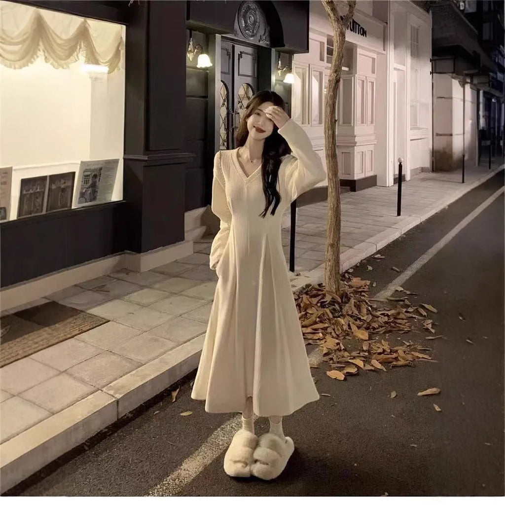 Women's white V-neck knitted dress with princess sleeves and a suspender skirt design.