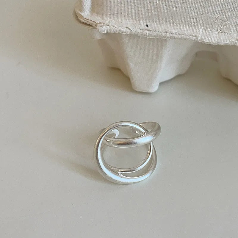 Women's geometric open ring with interlaced design in matte gold or silver tone metal