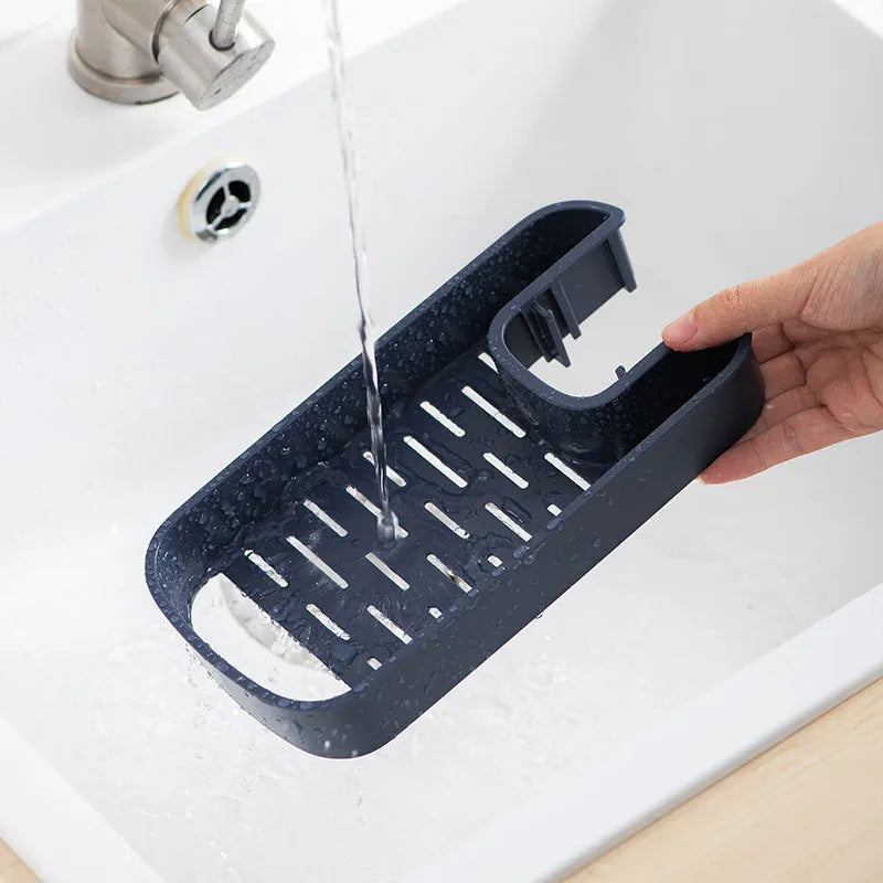 Blue sink shelf faucet holder with sponge and brush storage tray on a kitchen sink