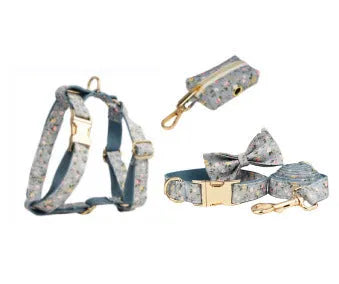 Blue floral patterned dog collar set with matching leash, bow, vest, and poop bag accessories