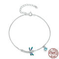 Sterling silver white gold plated dragonfly bracelet with dripping zircon stones on white background