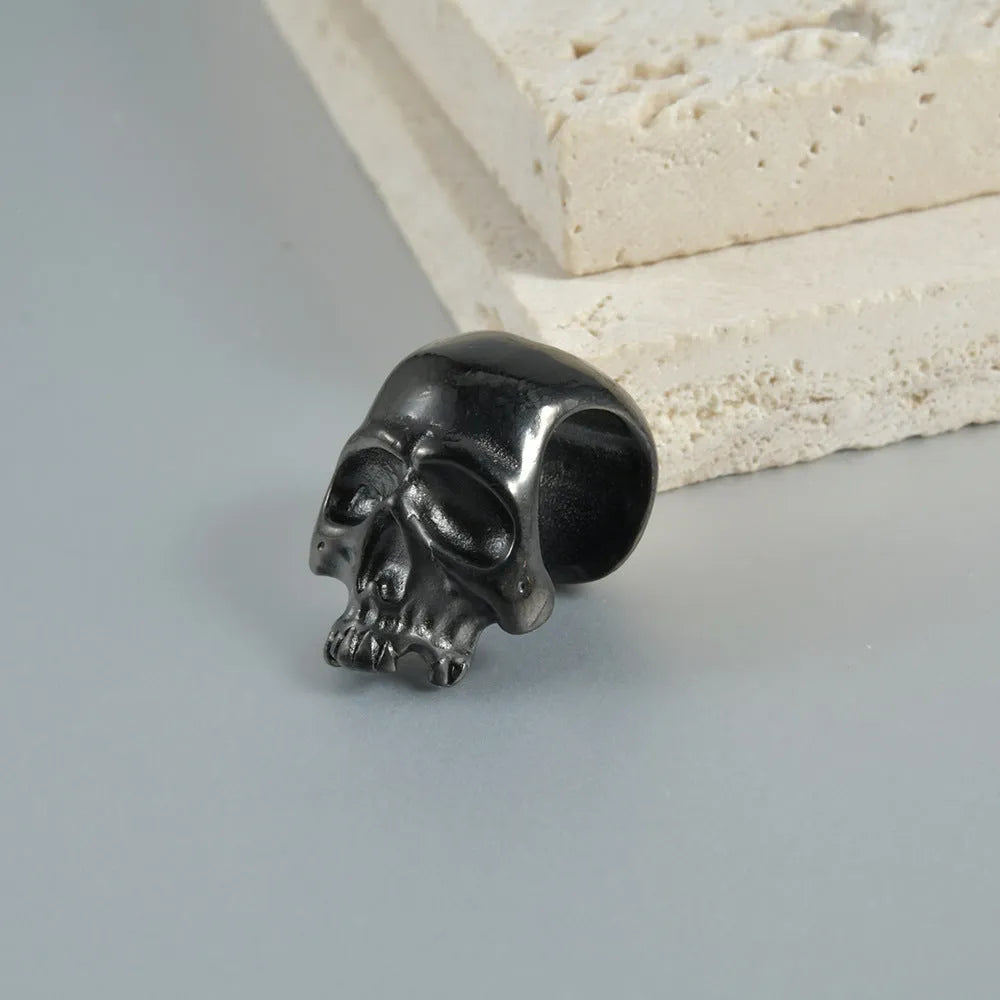 Stainless steel hollow skull Buddha earring in a geometry shape, shown in one of four colour options.