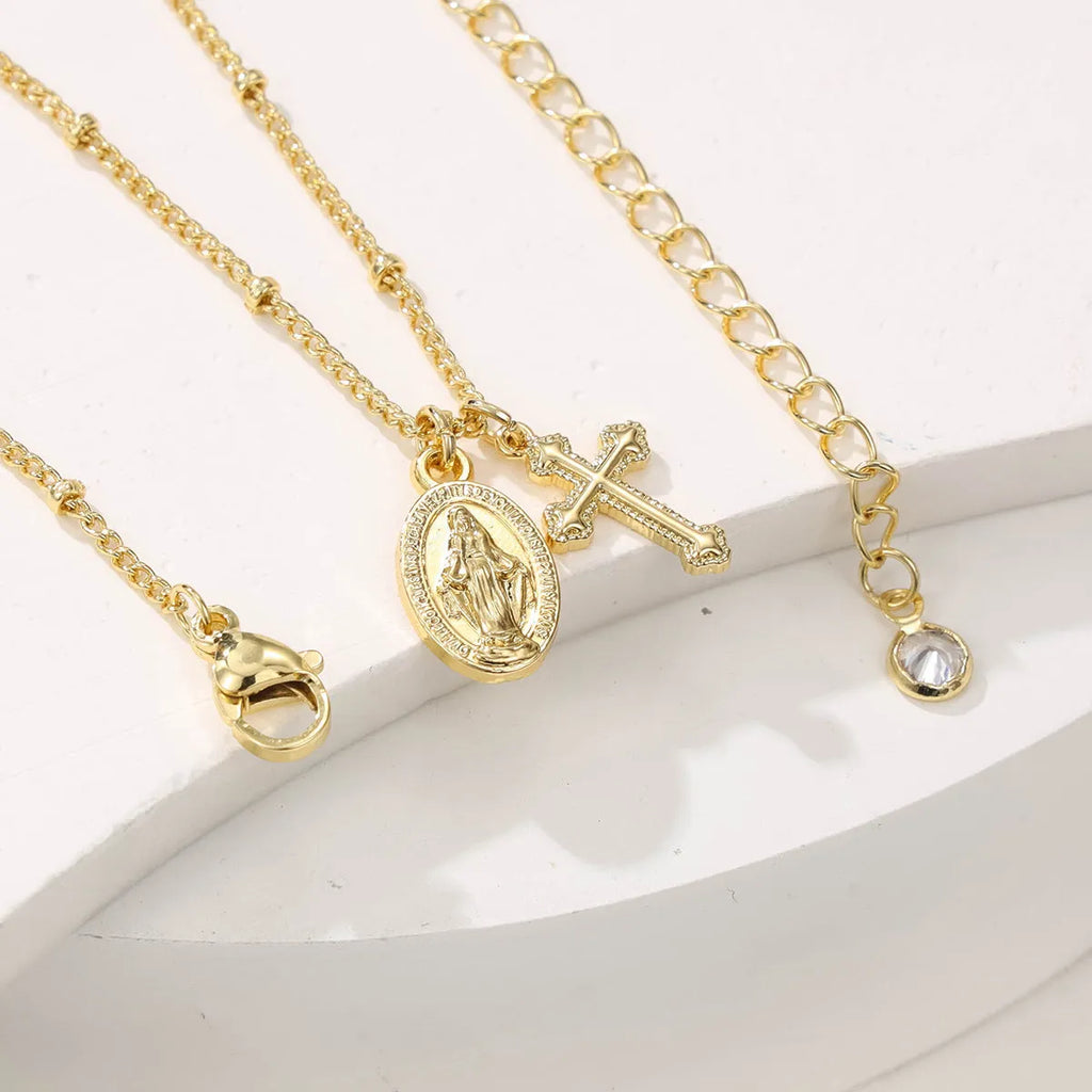 Geometric Virgin Mary cross pendant necklace in gold colour on a chain