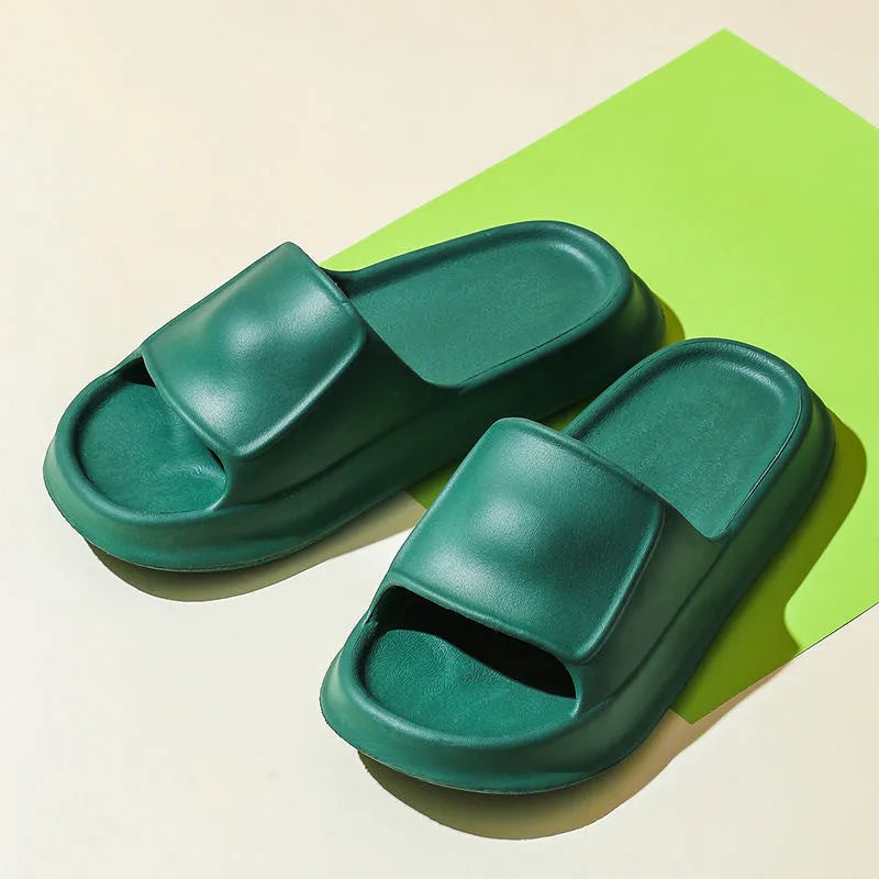 Pair of thick-soled EVA flip-flop slippers in a choice of seven colours, shown on a wet bathroom floor.
