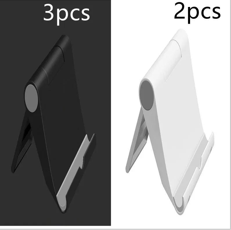 Black PE folding stand holding a smartphone at an angle on a wooden table.