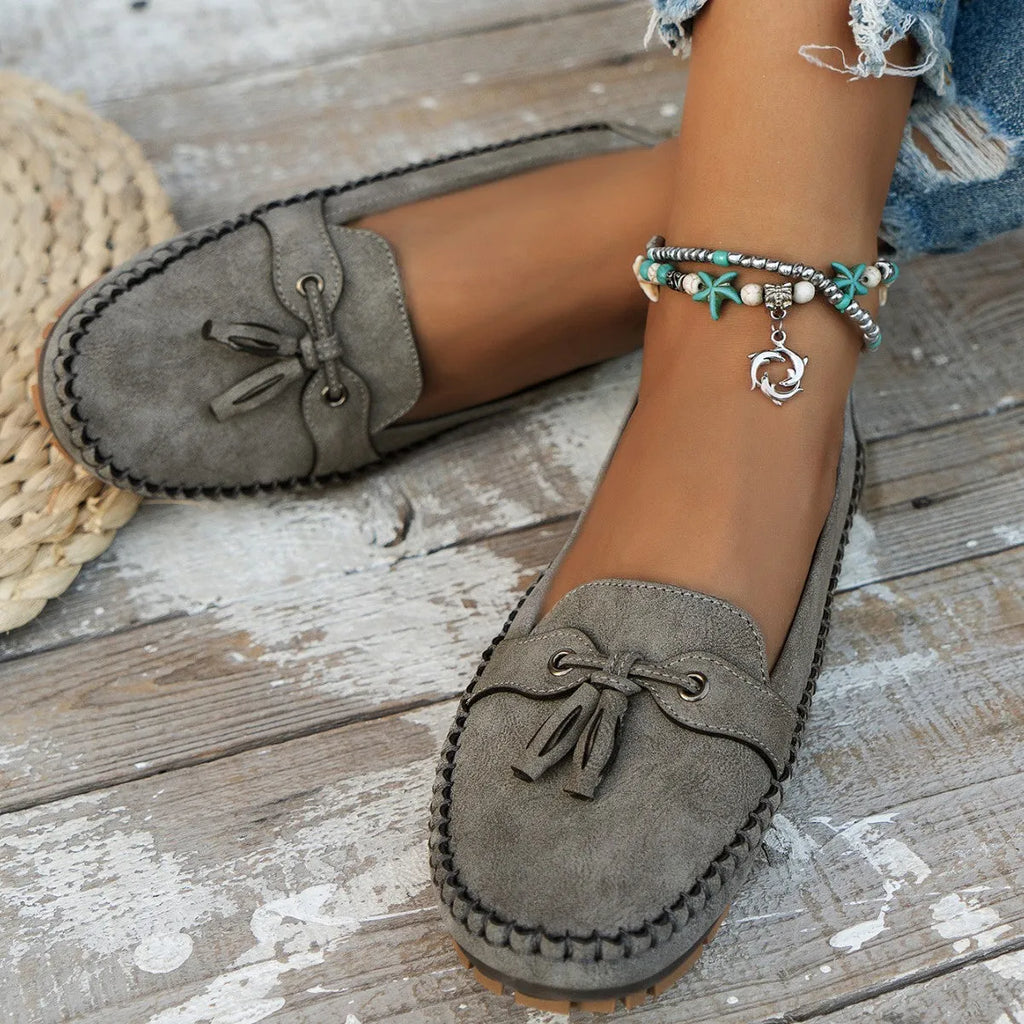 Women's casual flat shoes with bow detail in suede, shown in a solid colour.