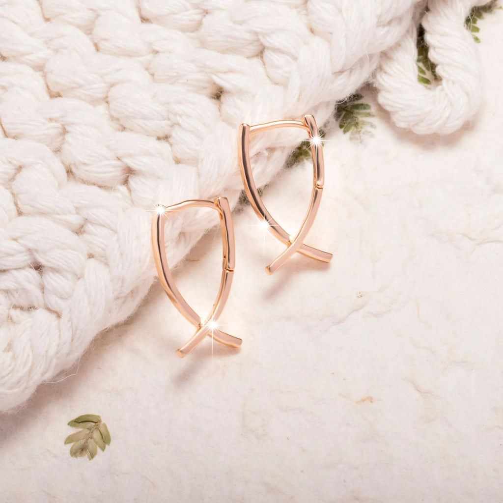 Rose gold copper cross shaped earrings with light luxury aesthetic