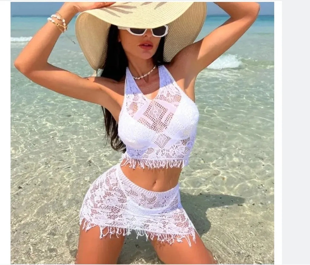 Women's two-piece bikini swimsuit with lace detail and attached tassel skirt cover-up in black or white