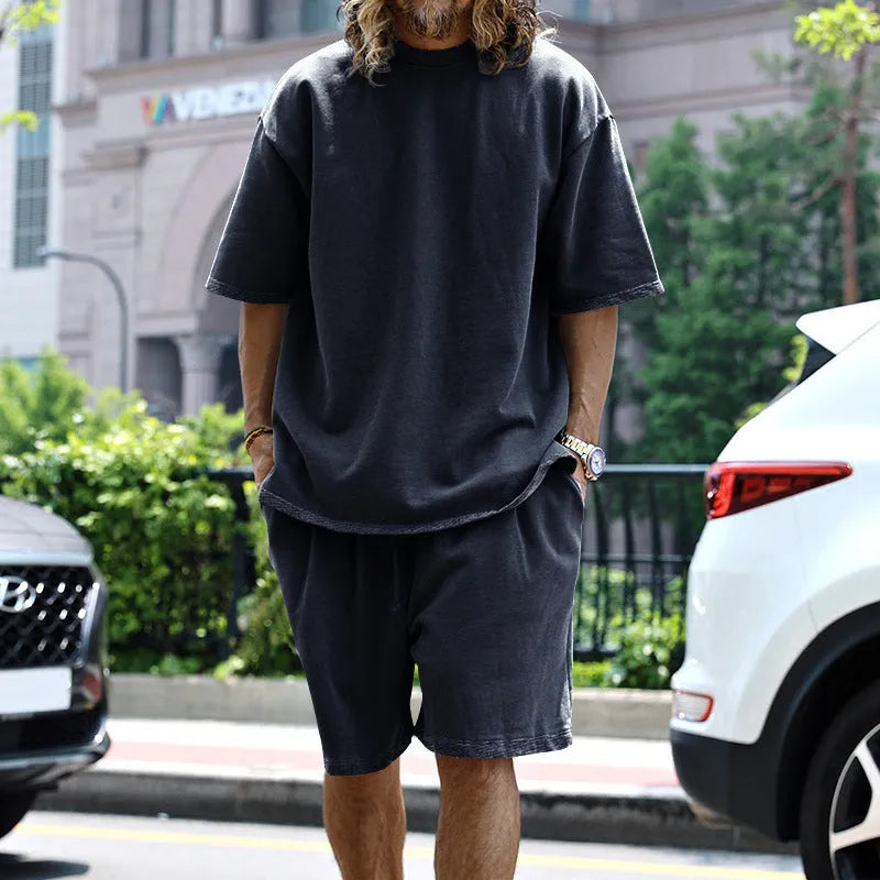 Men's casual sports suit set with grey round neck T-shirt and drawstring shorts on model