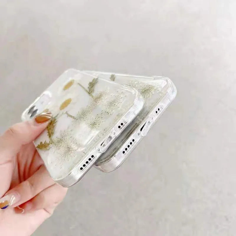 White iPhone case with epoxy daisy floral design on back cover, showing TPU protective construction