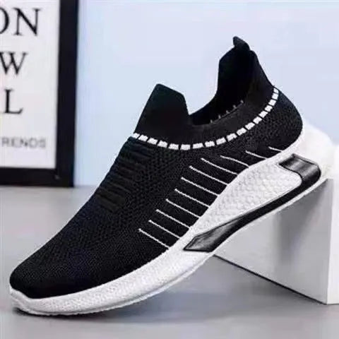 Men's black and white striped slip-on sneakers with lace-up front and mesh design.