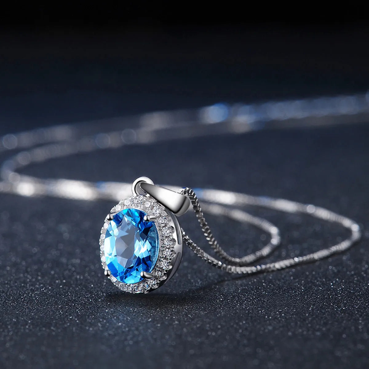 925 Sterling Silver four-piece jewellery set with Blue Topaz gemstones including earrings, ring, pendant and necklace