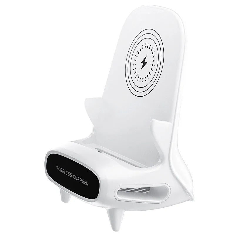 White chair-shaped wireless charging phone stand charging a smartphone on a desk