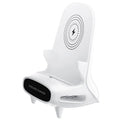 White chair-shaped wireless charging phone stand charging a smartphone on a desk